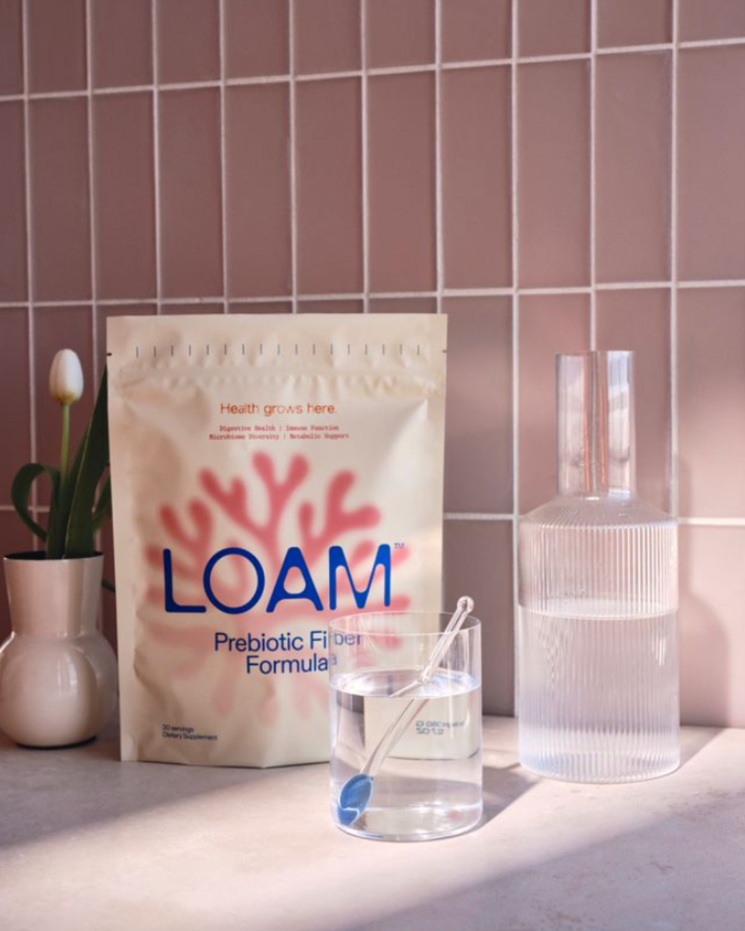 LOAM pouch beside a prepared drink